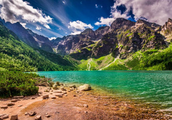 Fotobehang bergmeer in de ochtend met een helderblauw bergmeer, omringd door hoge bergen en een prachtig landschap.