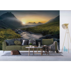 Een fotobehang van een bergrivier bij zonsondergang in een natuurlandschap in een woonkamer met vliesbehang.