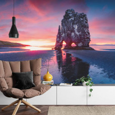 Een fotobehang met de iconische Hvitserkur-rots in IJsland bij zonsondergang met de zee op de achtergrond, ideaal voor een woonkamer.