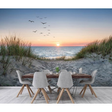 Fotobehang strand, duinen en zee bij zonsondergang met vogels en warme kleuren in een moderne keuken.